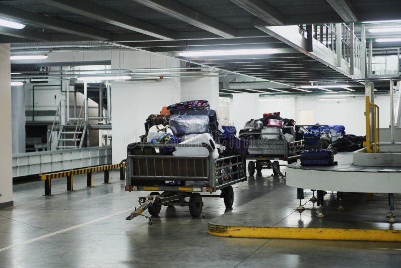 Loading and unloading operations and baggage control at the airport. Service for the transportation of belongings of aircraft stock photography