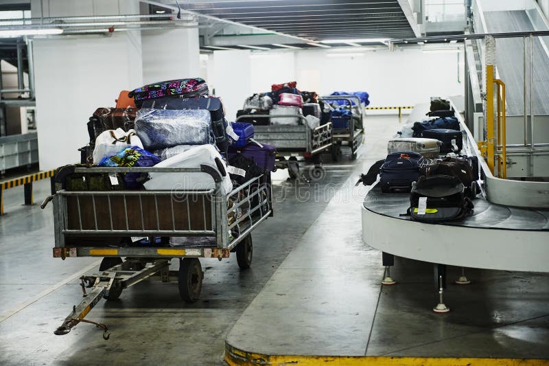 Loading and unloading operations and baggage control at the airport. Service for the transportation of belongings of aircraft royalty free stock photo
