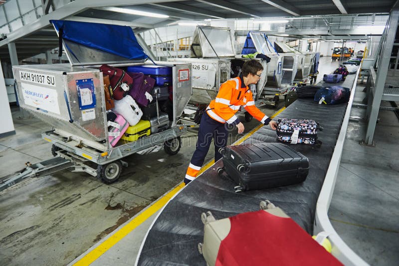 Loading and unloading operations and baggage control at the airport. Service for the transportation of belongings of aircraft stock photos