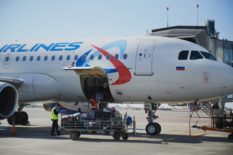 Loading and unloading operations and baggage control at the airport. Service for the transportation of belongings of aircraft royalty free stock images