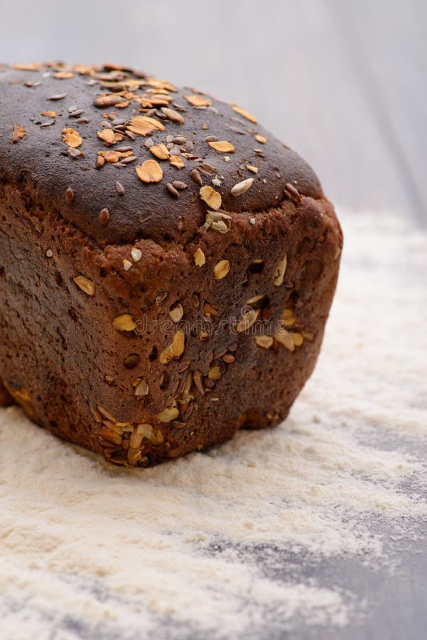 A Loaf of Black Bread with Flour on the Table Stock Image Image of
