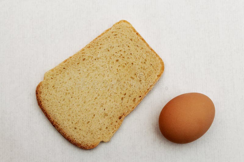Loaf of Bread and a Brown Egg. Stock Photo - Image of people, grey