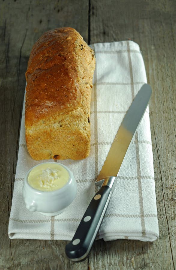 Loaf of bread with knife and butter