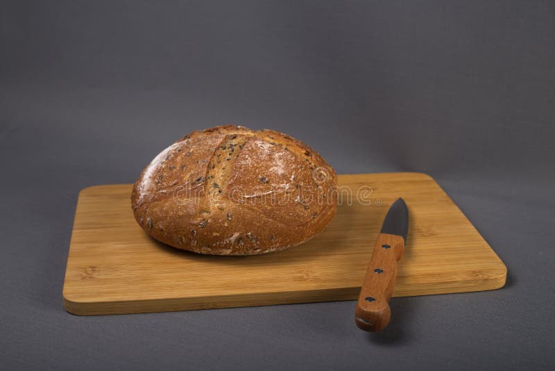 Loaf of Bread and a Knife on Cutting Board Stock Photo Image of board