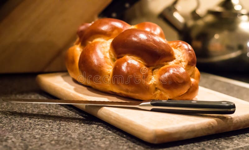 Loaf of challah bread with a knife