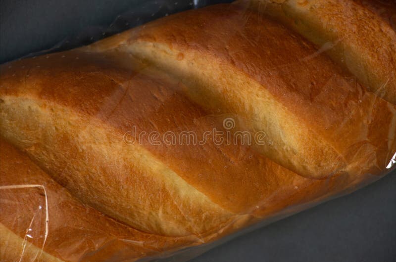 Loaf Of White Bread In A Package On A Dark Background Stock Photo