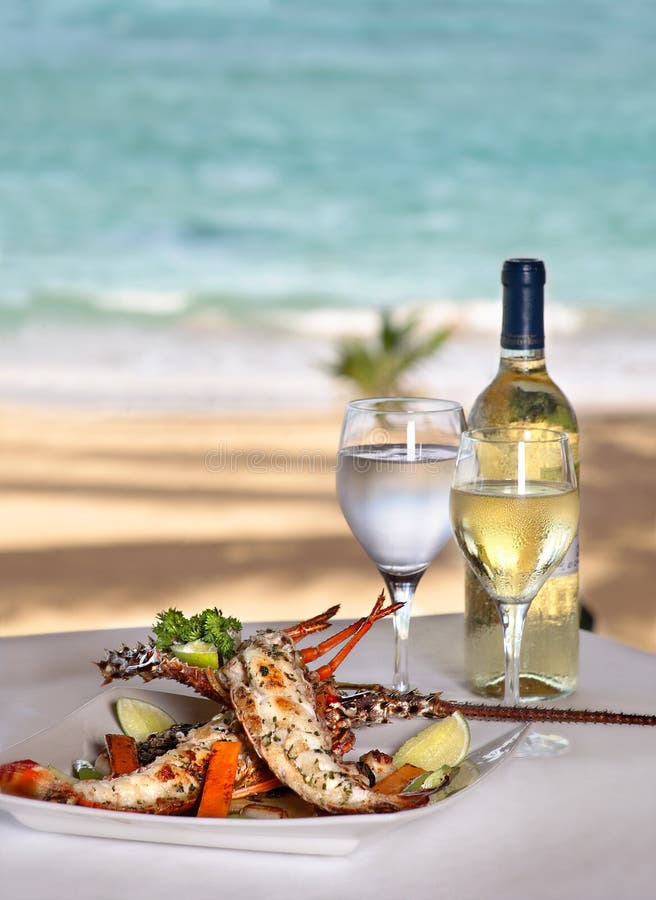 Lobster on the grill with lemon, in sea background