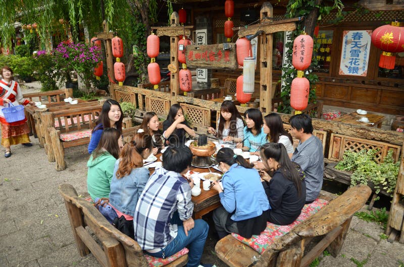 Local Chinese people eating on the streets on Ancient town of Lijiang, Yunnan, China. Local Chinese people eating on the streets on Ancient town of Lijiang, Yunnan, China