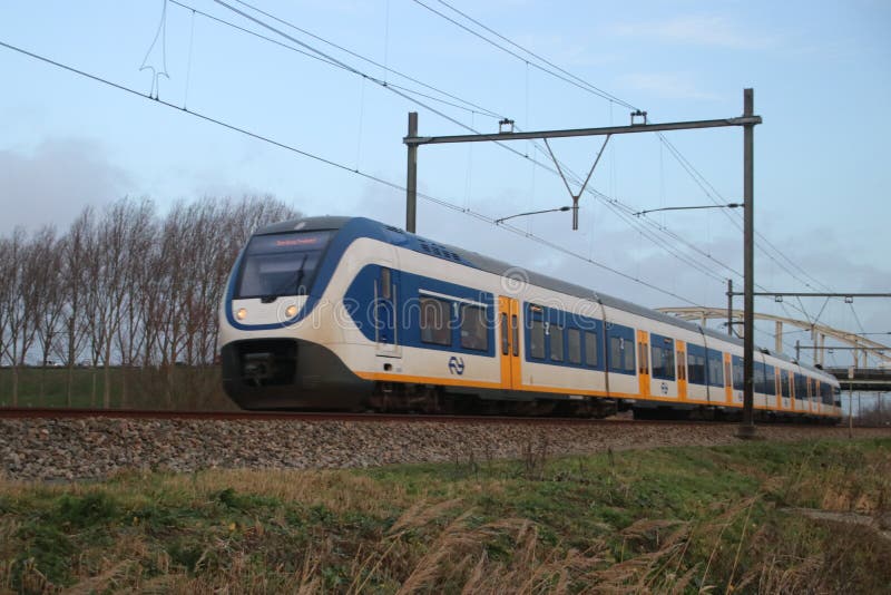 Local light rail communter train type SLT at railroad track between Gouda and The Hague royalty free stock photography