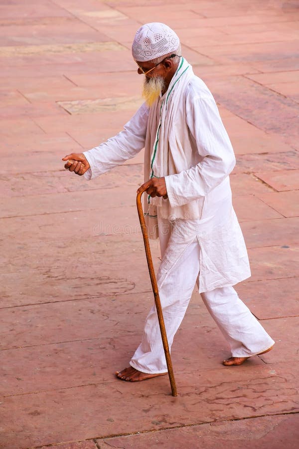 Local man walking in the courtyard of Jama Masjid in Fatehpur Sikri, Uttar Pradesh, India. The mosque was built in 1648 by Emperor Shah Jahan and dedicated to his daughter Jahanara Begum