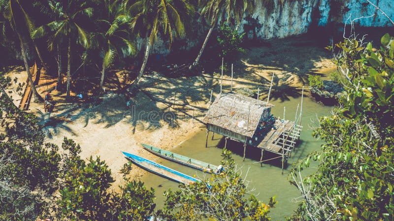 Local people tap new location, Bamboo Hut and Boats on Beach in low Tide, Kabui Bay near Waigeo. West Papuan, Raja Ampat royalty free stock images Local people tap new location, Bamboo Hut and Boats on Beach in low Tide, Kabui Bay near Waigeo. West Papuan, Raja Ampat royalty free stock images