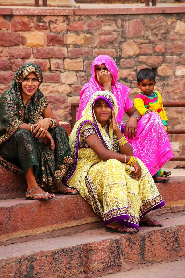 Local women sitting on the steps outside Jama Masjid in Fatehpur Sikri, Uttar Pradesh, India. The mosque was built in 1648 by Emperor Shah Jahan and dedicated to his daughter Jahanara Begum