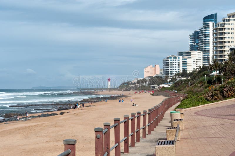 Locals and tourists on the beach near the Millennium Pier and lighthouse in Umhlanga Rocks stock photography Locals and tourists on the beach near the Millennium Pier and lighthouse in Umhlanga Rocks stock photography