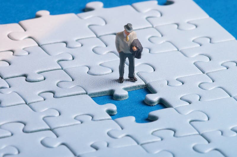 Plastic figure standing in front of a hole in a puzzle. Plastic figure standing in front of a hole in a puzzle