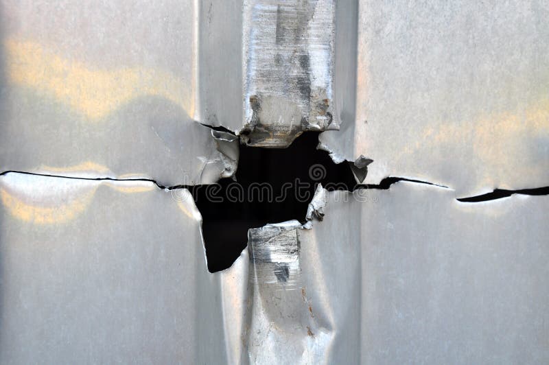 Punched hole in metal sheet, metallic background. Punched hole in metal sheet, metallic background.