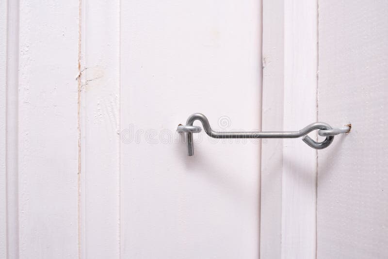 A Locked Metal Door Hook on White Wooden Door, Simple Device for