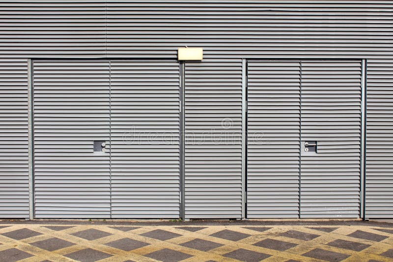 Locked Metal Doors on Industrial Complex Building Covered with Metal