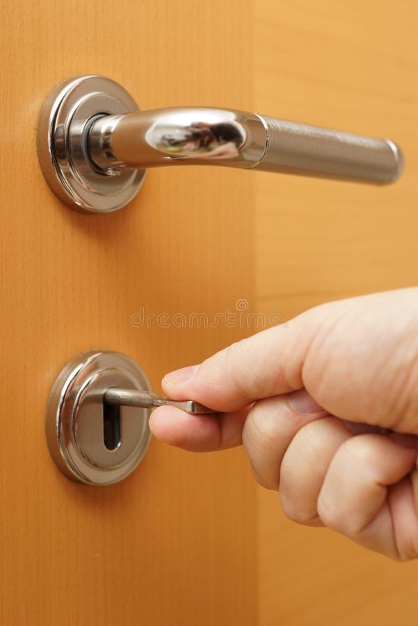 Locking up or unlocking door with key in hand royalty free stock images