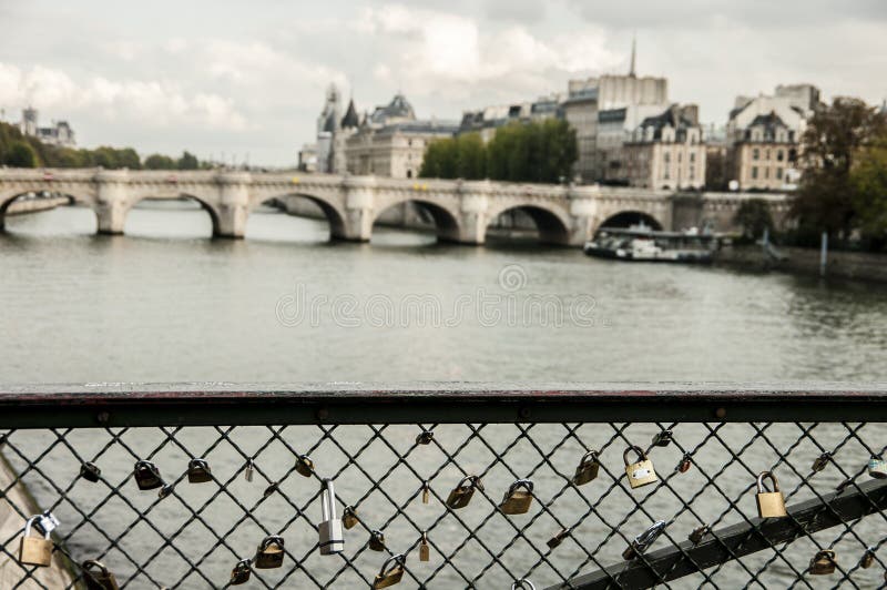 Locks that hang on the railing on the bridge over the Seine stock images