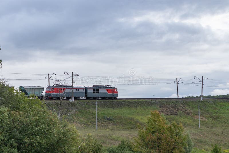 Locomotive and freight cars traveling by rail. Tula region, Russia stock photo Locomotive and freight cars traveling by rail. Tula region, Russia stock photo