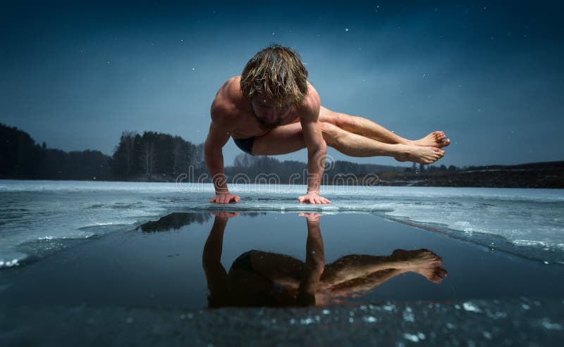 Man doing yoga exercise, parsva bakasana, on the ice of frozen lake. Man doing yoga exercise, parsva bakasana, on the ice of frozen lake