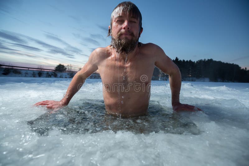 Young man bathing in the ice hole. Young man bathing in the ice hole