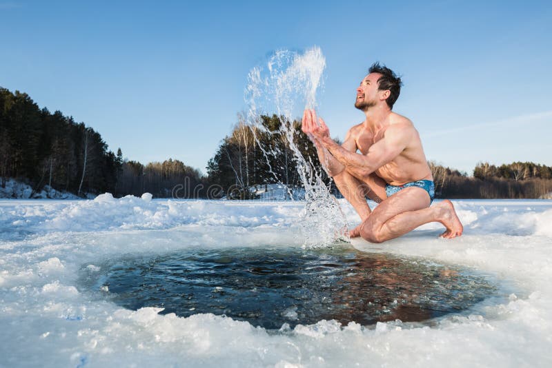 Young man having fun near the ice hole. Young man having fun near the ice hole