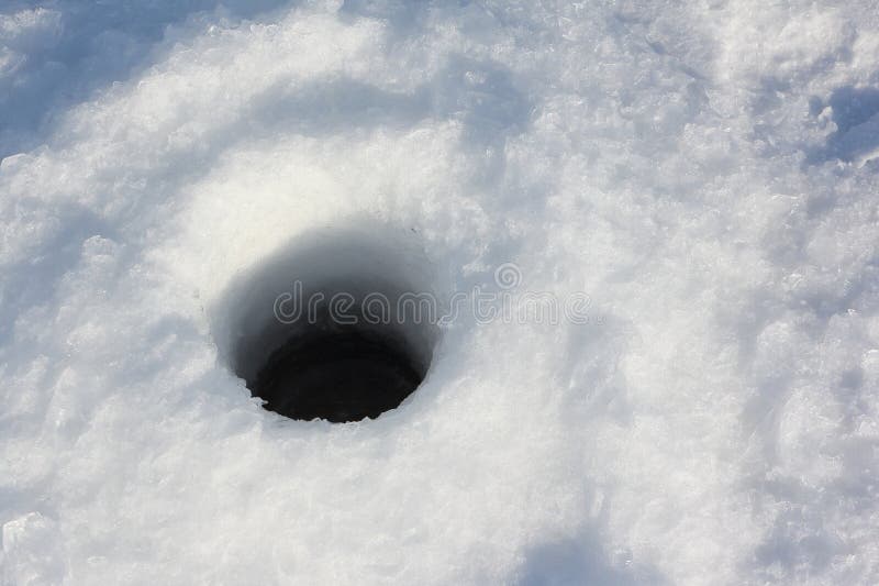 Ice fishing hole on the surface of river in winter. Ice fishing hole on the surface of river in winter