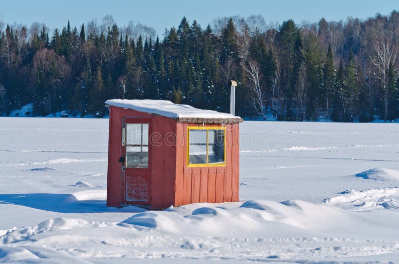 Orange and yellow Ice fishing cabin on lake in Quebec. Orange and yellow Ice fishing cabin on lake in Quebec