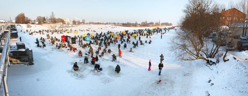 Liepaja, Latvia - January 21, 2013: People ice fishing event on frozen river in Liepaja. Liepaja, Latvia - January 21, 2013: People ice fishing event on frozen river in Liepaja.