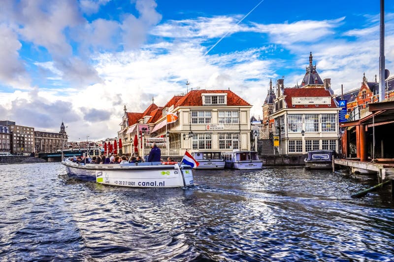 Loetje Centraal Restaurants and Tourist Office on the Damrak Canal Near  Central Station in the Old City Center of Amsterdam Editorial Image - Image  of house, cityscape: 123546435