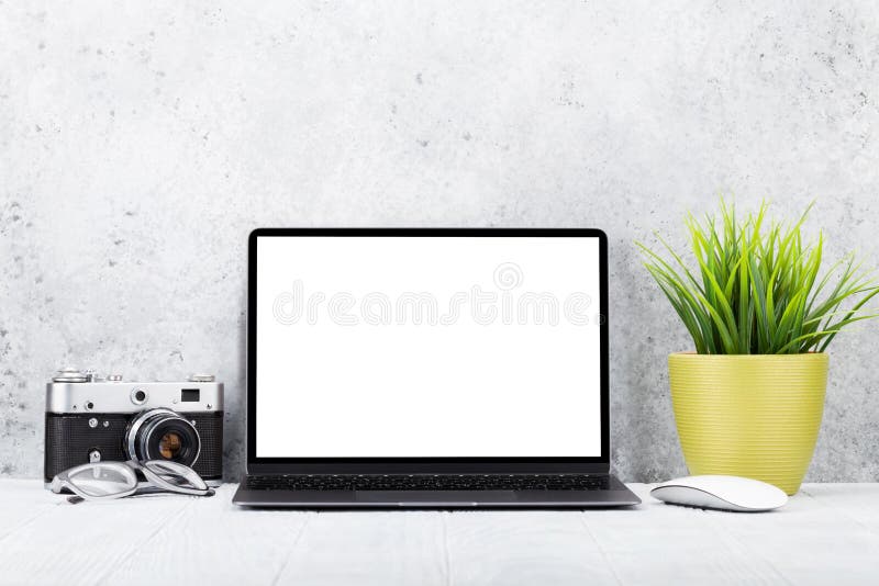 Loft home office workplace with blank white screen laptop computer and accessories. With copy space for your mockup or text. Loft home office workplace with blank white screen laptop computer and accessories. With copy space for your mockup or text