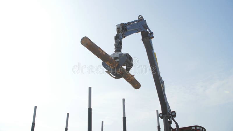 Log loader or forestry machine moves fresh cut logs for loading stock photos