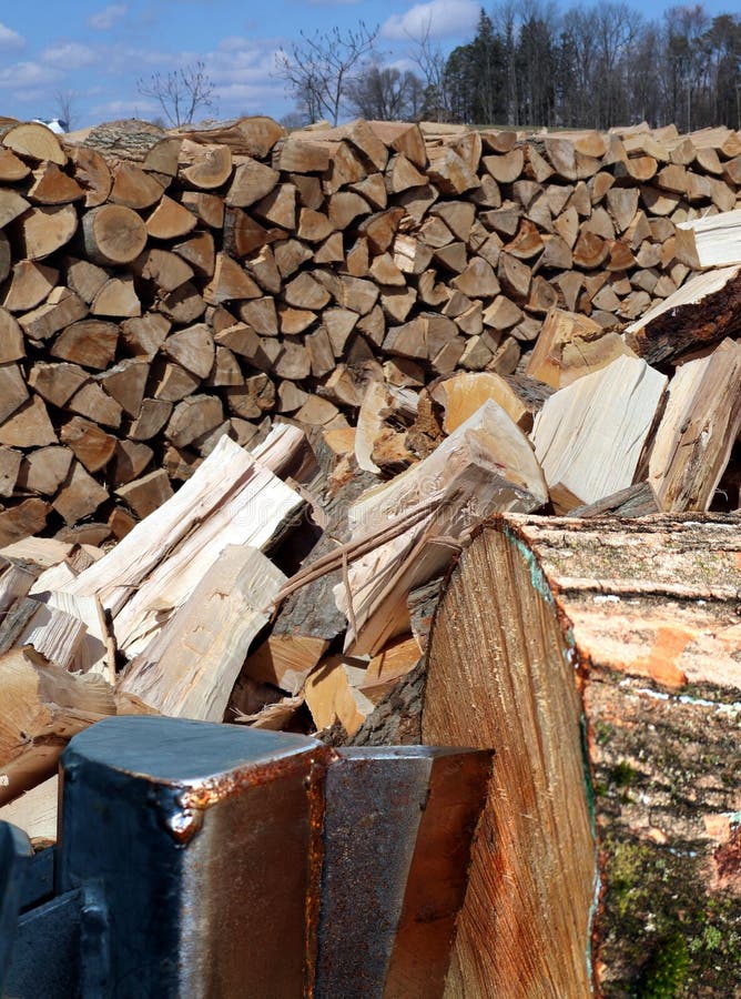 Log Spliter Wedge Splitting Piece of Wood with Cords of Wood Pile Behind Stock Image - Image of