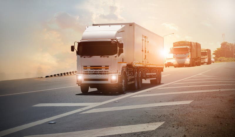 Logistics import export and transport industry, Semi trailer truck on a highway driving on sunset background