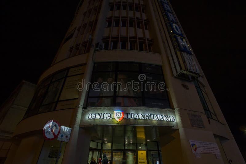 Logo of Banca Transilvania Bank of Transylvania at night on a Brasov office of the company.