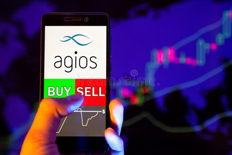 Logo dell'azienda Agios Pharmaceuticals Inc. su smartphone screen, mano del commerciante che tiene in mano un telefono cellulare immagine stock libera da diritti Logo dell'azienda Agios Pharmaceuticals Inc. su smartphone screen, mano del commerciante che tiene in mano un telefono cellulare immagine stock libera da diritti