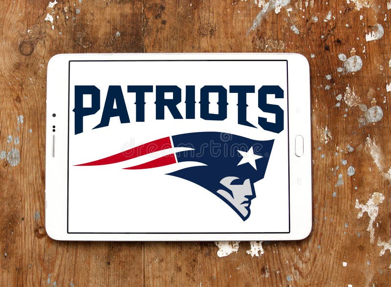 Logo of New England Patriots american football team on samsung tablet on wooden background. The New England Patriots are a professional American football team based in the Greater Boston region. Logo of New England Patriots american football team on samsung tablet on wooden background. The New England Patriots are a professional American football team based in the Greater Boston region