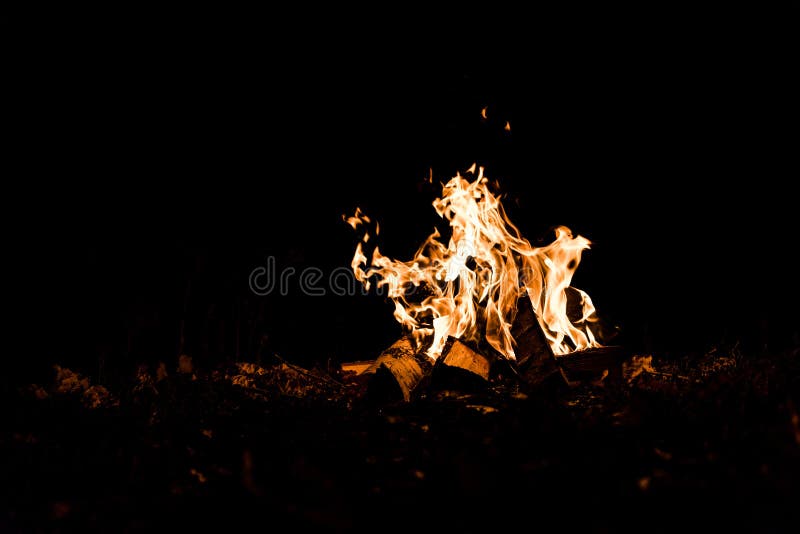 Logs burning in camp fire stock images