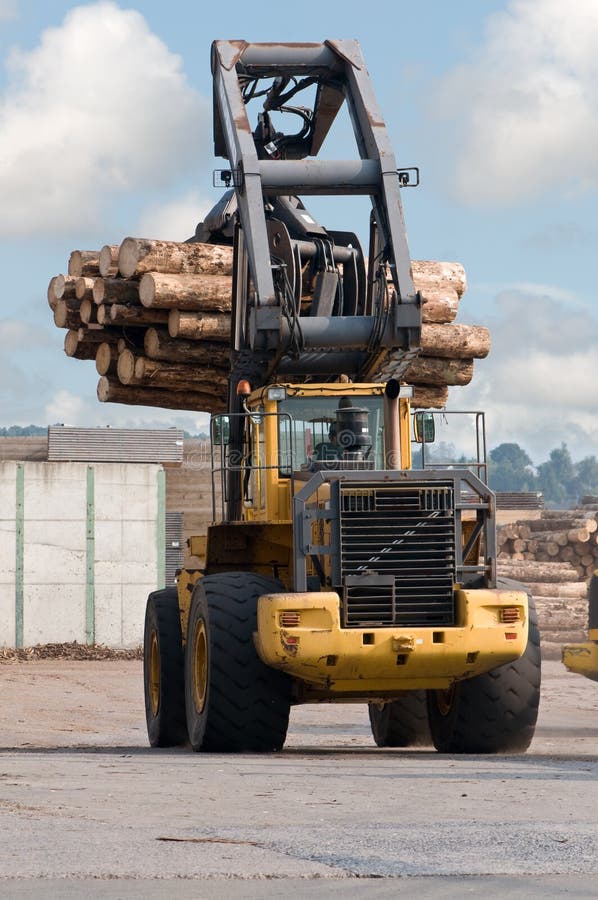 Skidder hauling logs at sawmill. Claw machine stock images, royalty-free photos and pictures