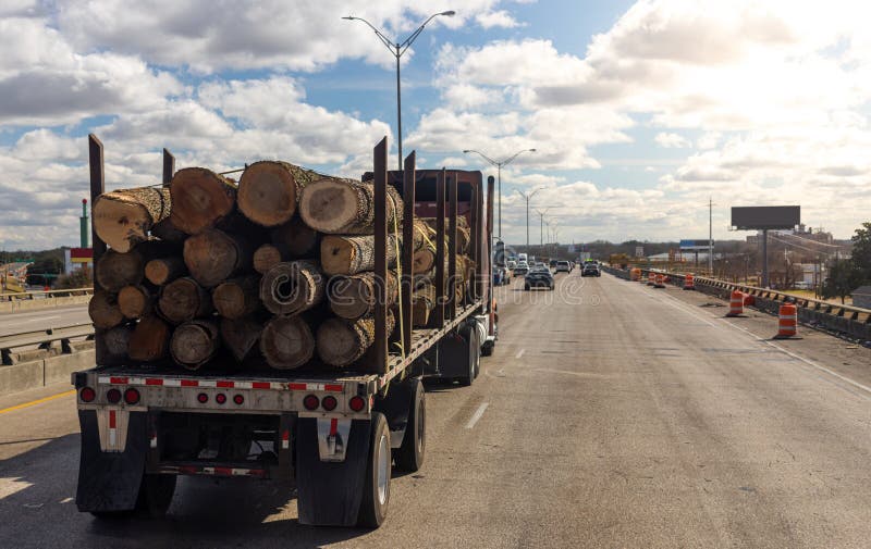 Logs Transportation by Heavy Duty Truck on the Highway. Oversize Transport of Timber in USA
