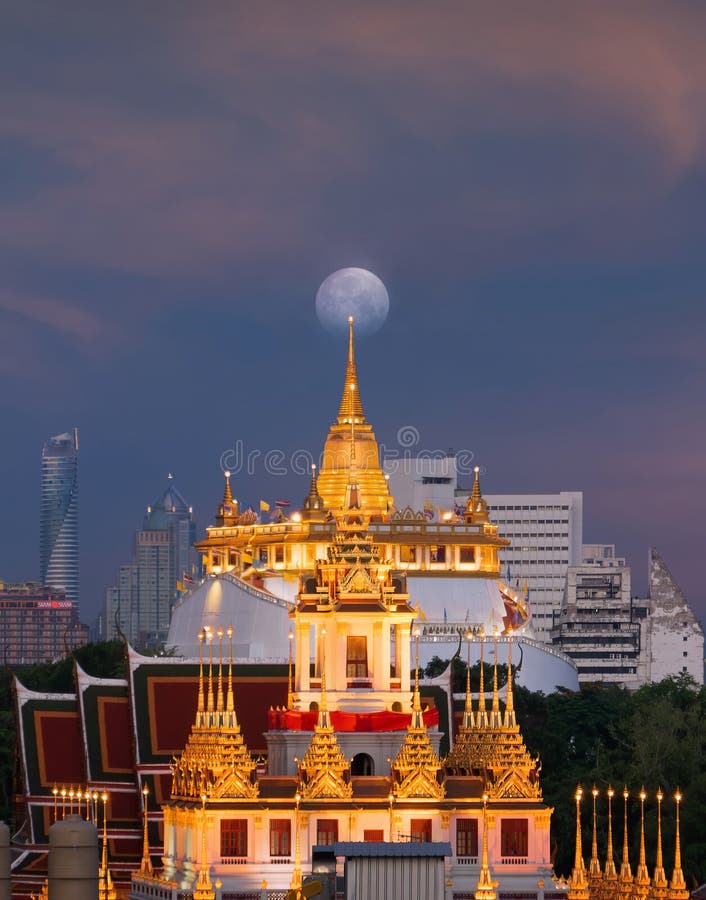 Loha Prasat Wat Ratchanatda and Golden Mountain pagoda, a buddhist temple or Wat Saket and the moon with skyscraper buildings in