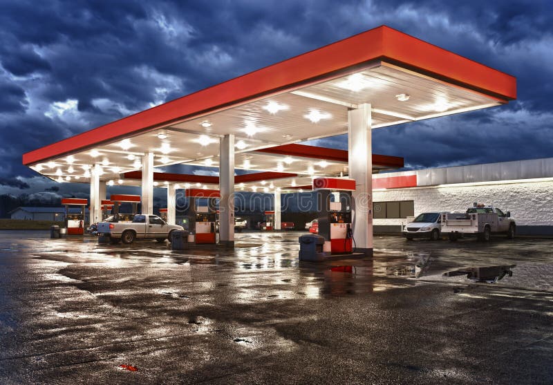 An High Dynamic Range image of a gasoline station and convenience store after an evening rain. All identifying logos and trademarks have been removed, and stationâ€™s original color scheme has been replaced. An High Dynamic Range image of a gasoline station and convenience store after an evening rain. All identifying logos and trademarks have been removed, and stationâ€™s original color scheme has been replaced.