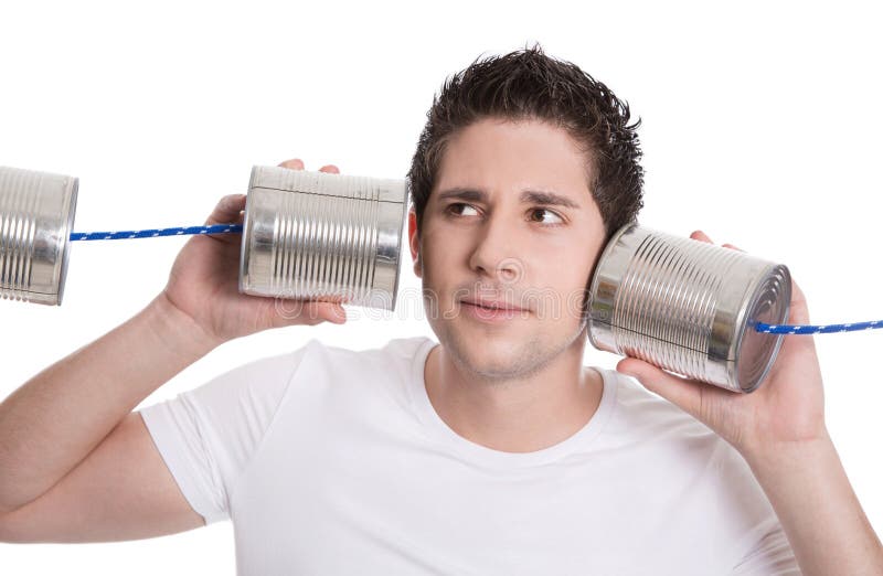 Isolated young man in white holding tin can. Communication or decision concepts. Isolated young man in white holding tin can. Communication or decision concepts.