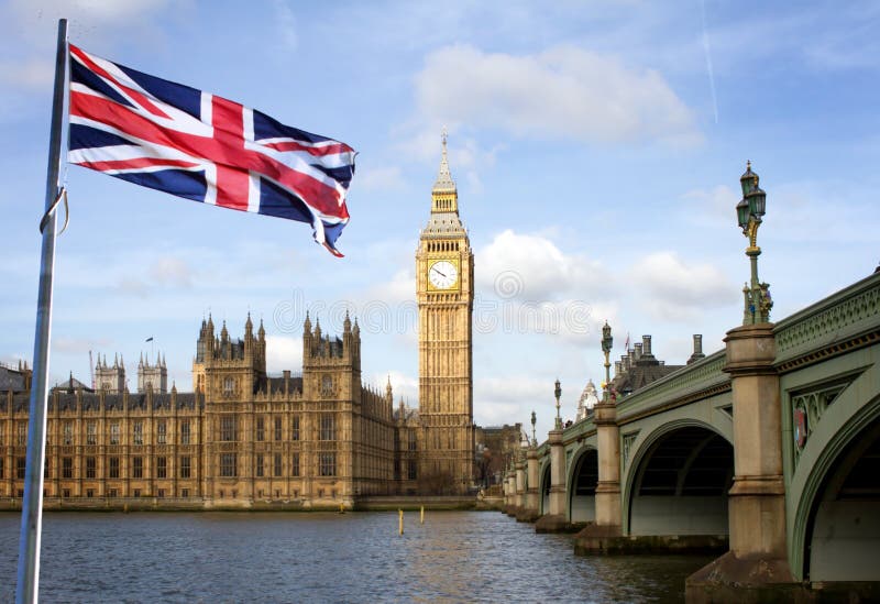 London Big Ben and Westminster bridge and british flag against blue sky. London Big Ben and Westminster bridge and british flag against blue sky