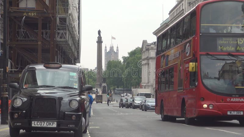 London city with car traffic and crowded streets double decker buses and taxi