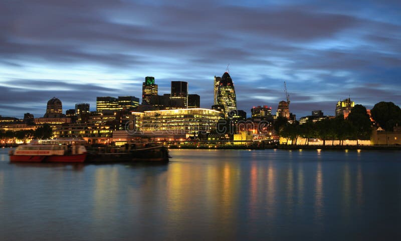 View of the City in London at night with the new buildings still under construction. View of the City in London at night with the new buildings still under construction.