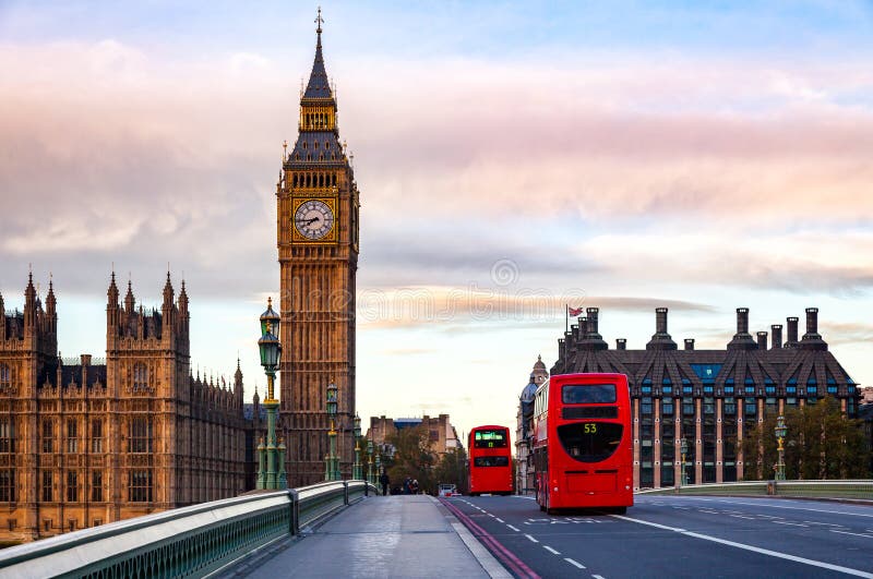 London morning traffic scene with red Double Decker buses move along the Westminster Bridge with Palace of Westminster Elizabeth Tower aka Big Ben in background. London morning traffic scene with red Double Decker buses move along the Westminster Bridge with Palace of Westminster Elizabeth Tower aka Big Ben in background