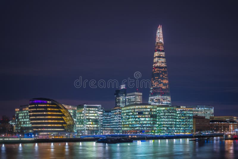 London, England - City Hall of London and offices with famous Shard skyscraper by night