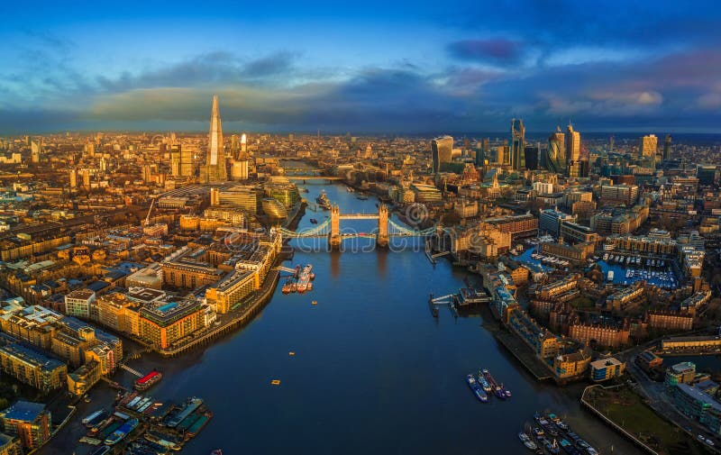 London, England - Panoramic aerial skyline view of London including iconic Tower Bridge with red double-decker bus